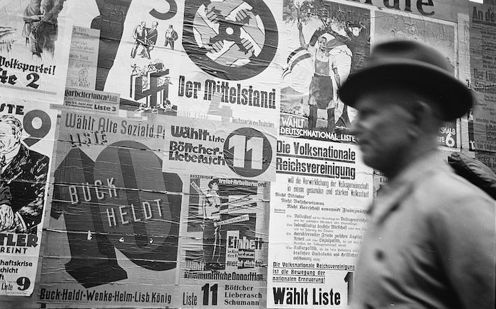 A man walks past a wall of election posters in Leipzig, by Albert Henning, 12 May 1929. © Deutsche Fotothek / Hennig, Albert. All rights reserved.